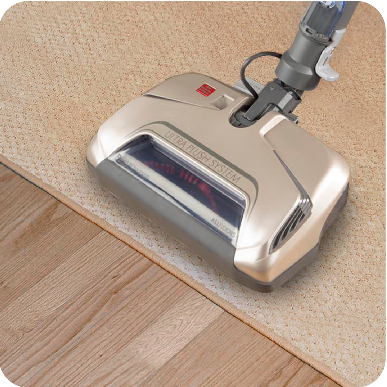 Vacuum cleaner on a transition strip between carpet and wooden floor