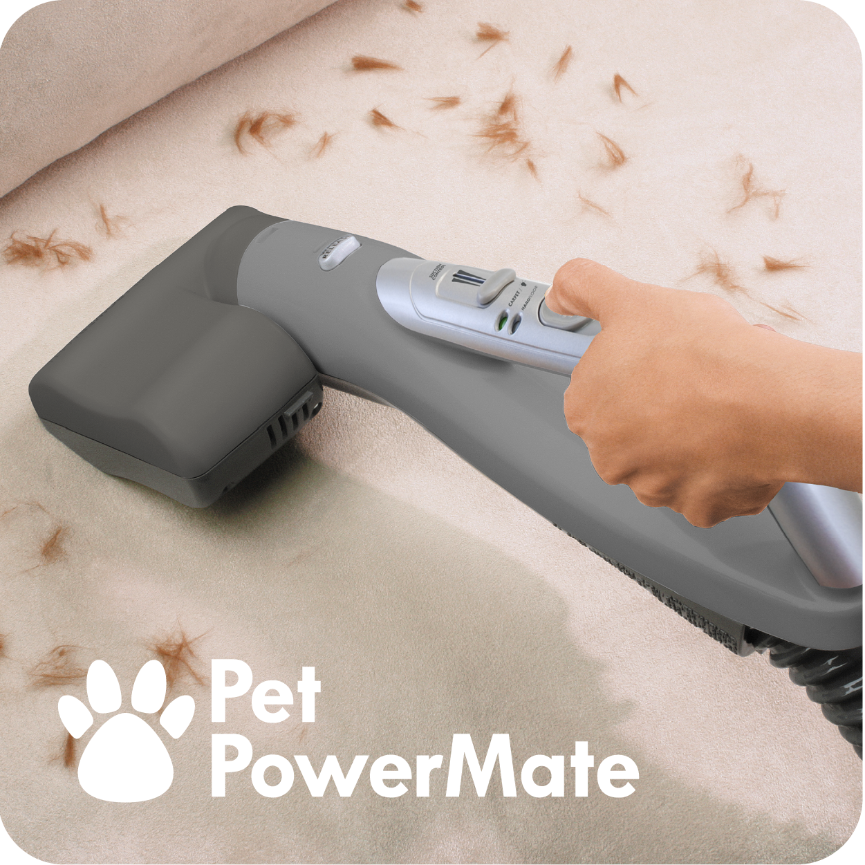 Close up image of person using Pet PowerMate to clean up pet hair from upholstered furniture.