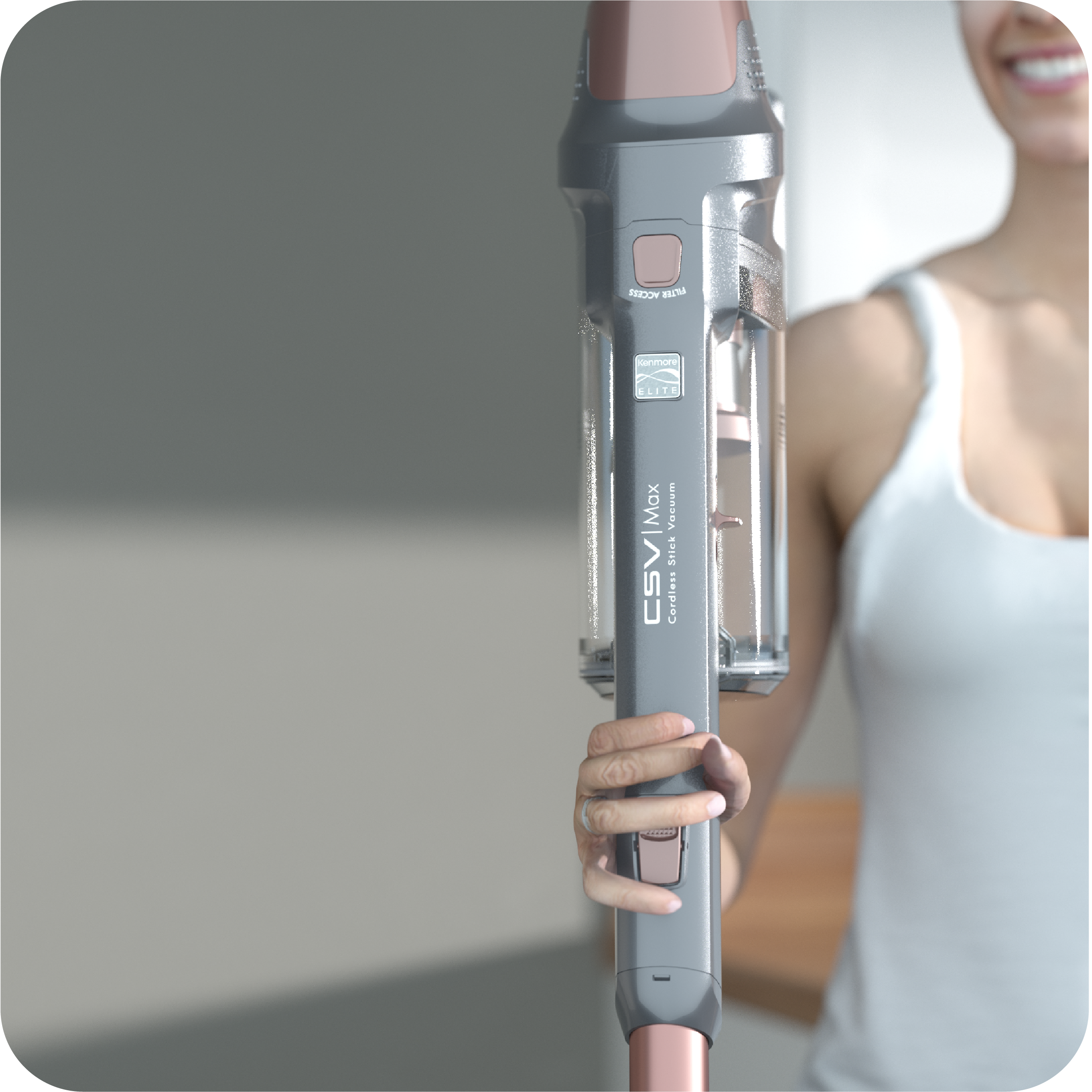 Person holding a gray and pink stick vacuum cleaner to show it's lightweight with a blurred background