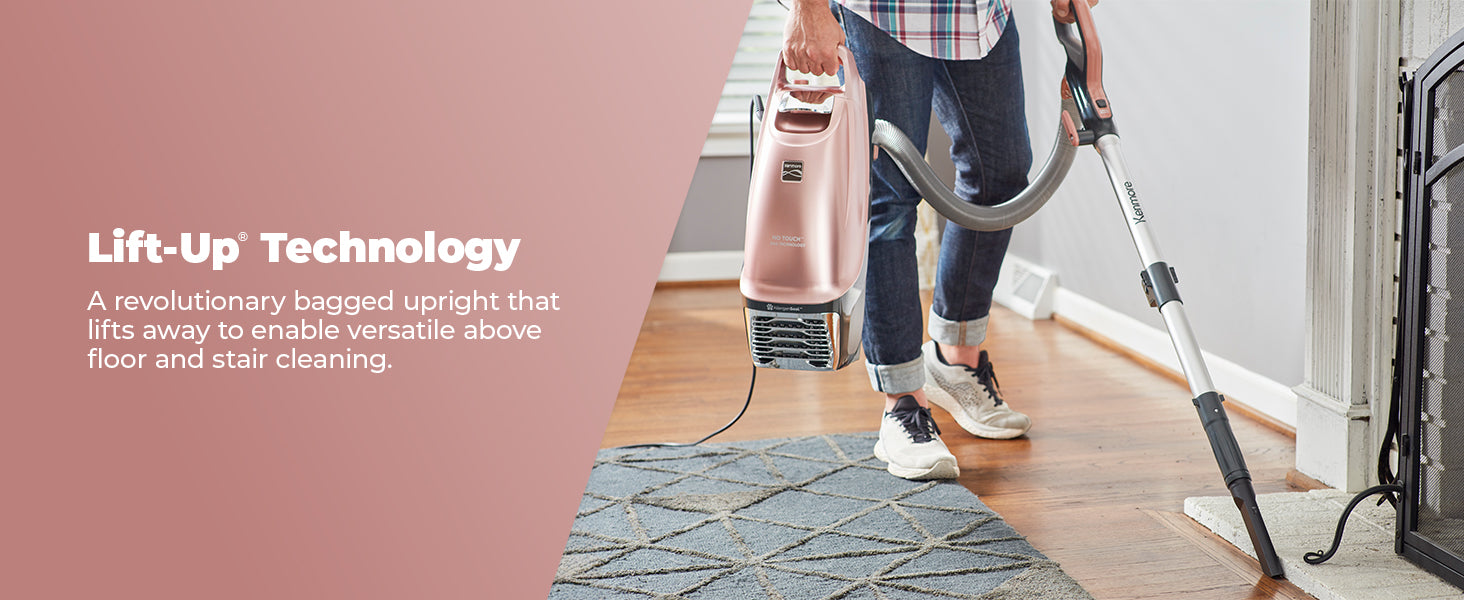 Person using a vacuum cleaner with 'Lift-Up Technology' feature on a wooden floor.