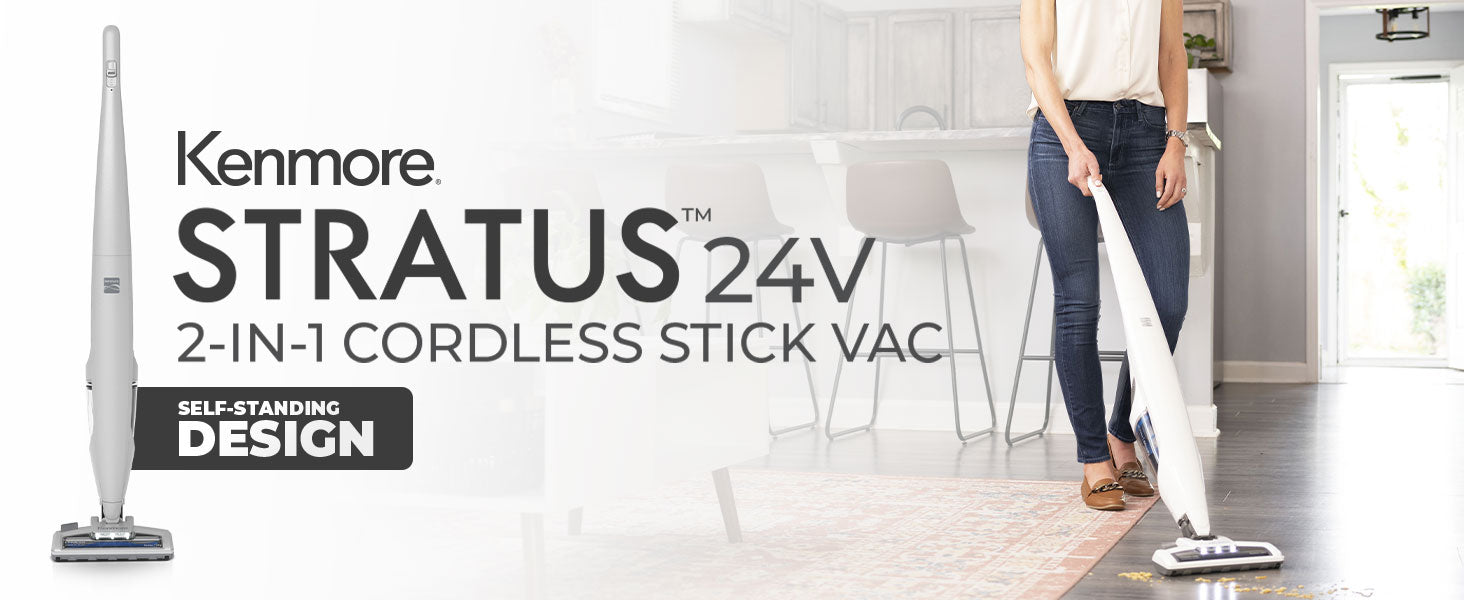 Person using a Kenmore Stratus 24V cordless stick vac in a home setting.