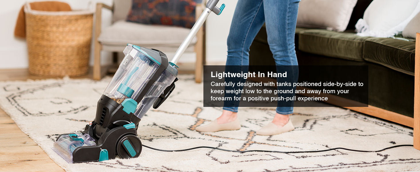 Person using a carpet cleaner on a rug in a living room setting