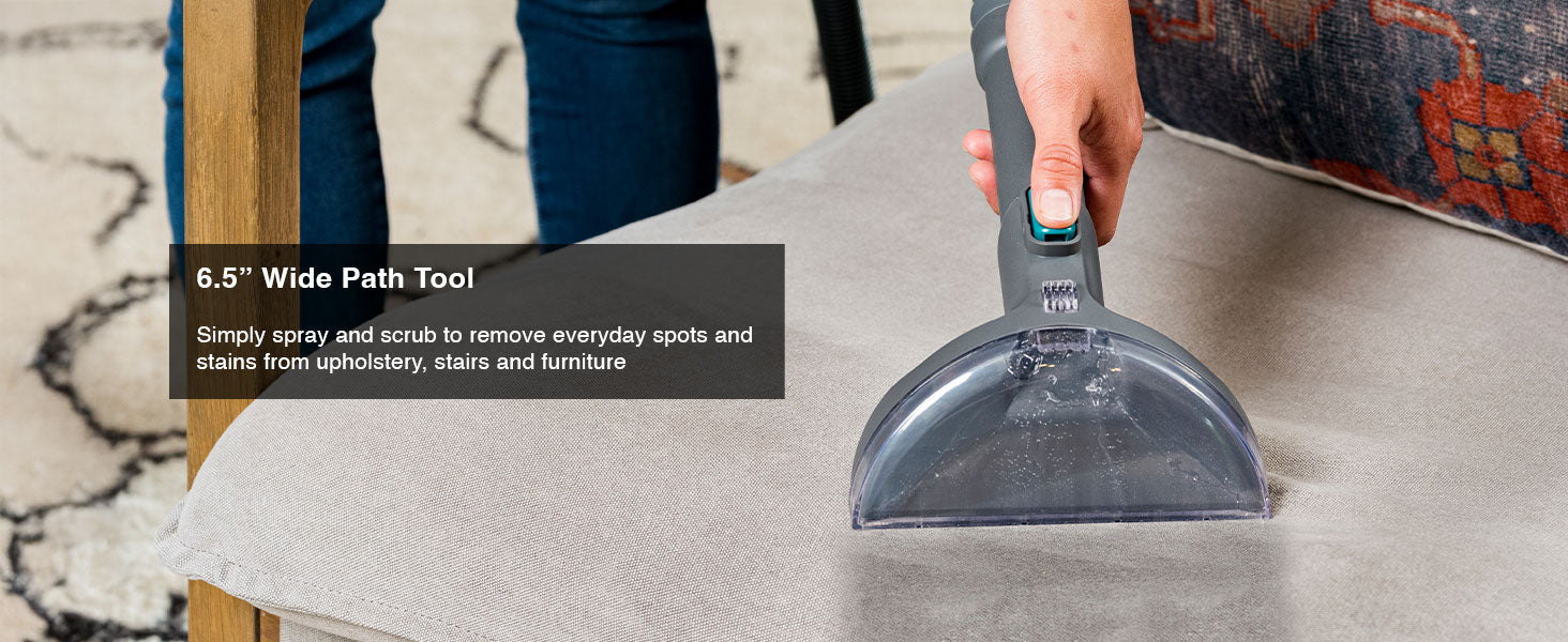 Upholstery tool being used on a chair cushion with text about its wide path and cleaning capabilities.