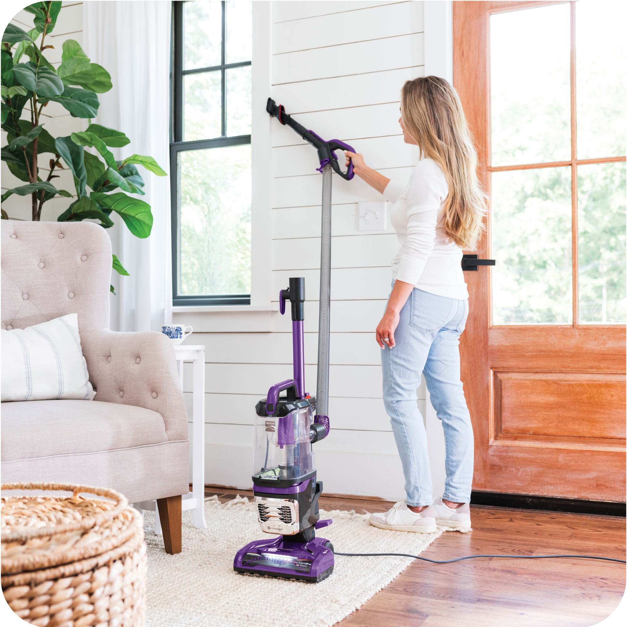 Woman using a vacuum cleaner in a home setting