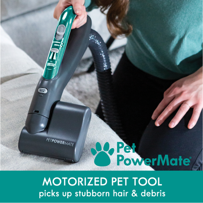 Person using a Pet PowerMate motorized pet tool on a couch